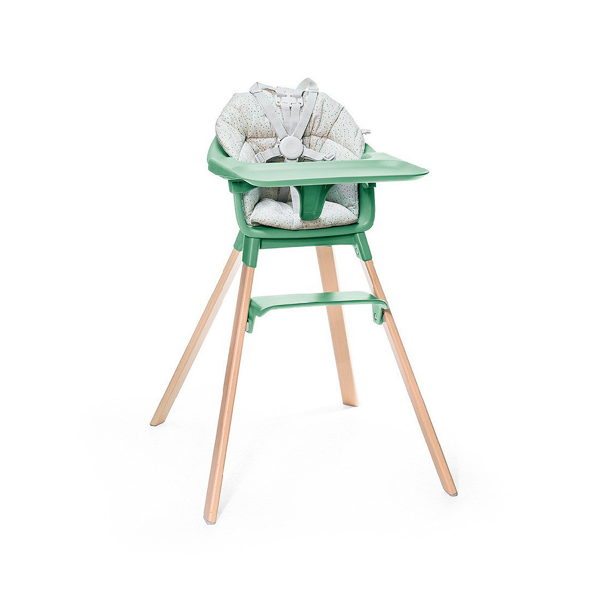 Cojín trona Clikk de Stokke, trona de color verde trebol y patas de madera.