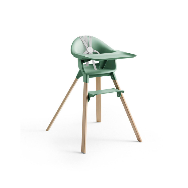 Trona Clikk de Stokke en color verde y patas de madera de haya. Incluye bandeja y arnés.