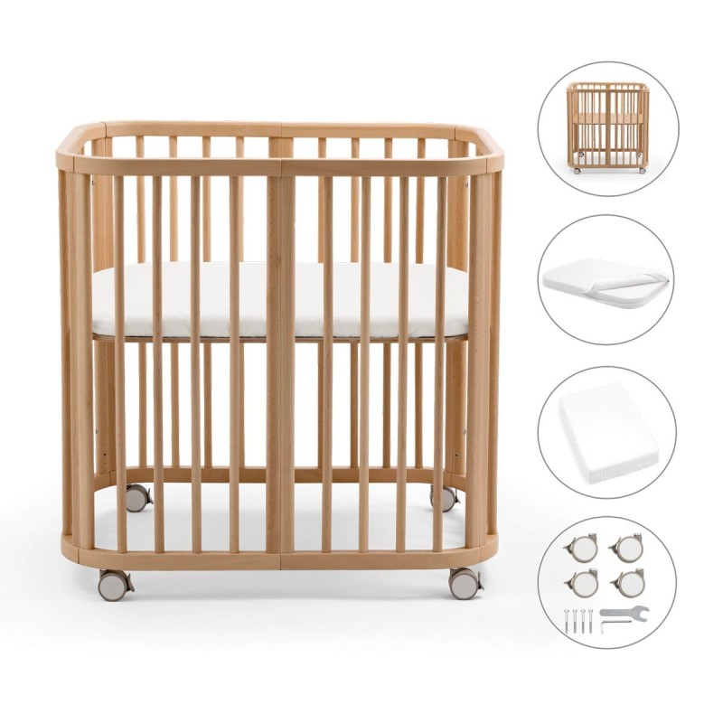 pack de la minicuna Stokke Nighti MINI que incluye cuna, colchón, sábana bajera y ruedas